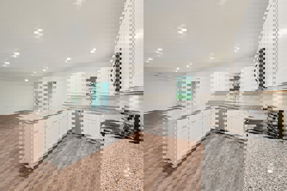 A kitchen with white cabinets.