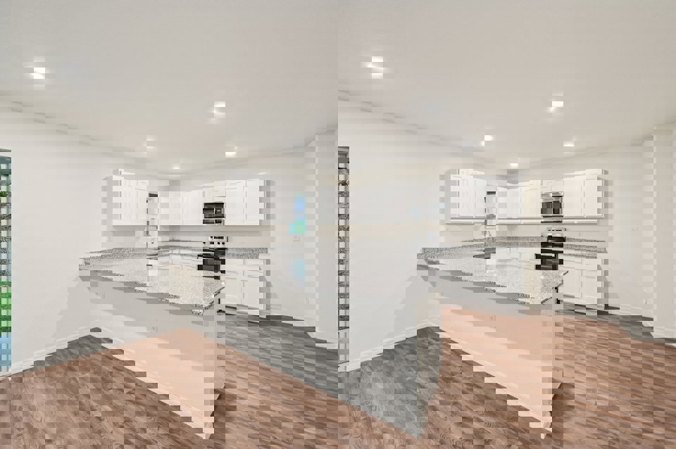 A kitchen with white cabinets.