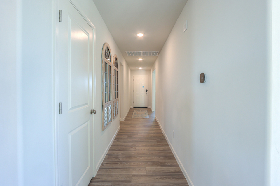A hallway with white doors.