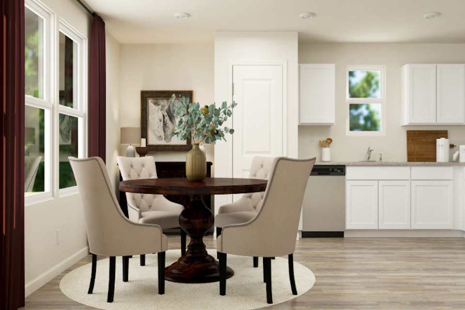 A dining room with a table and chairs.