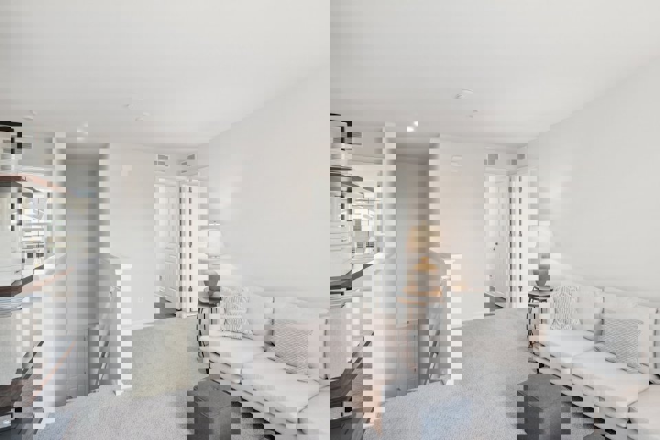 A living room with white furniture.