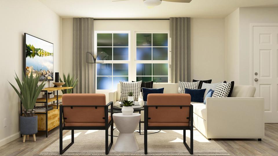 A living room with a couch and chairs.