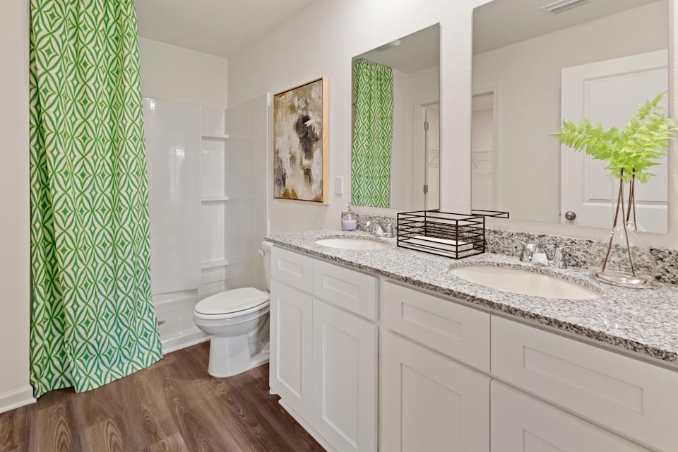 A bathroom with a large mirror.