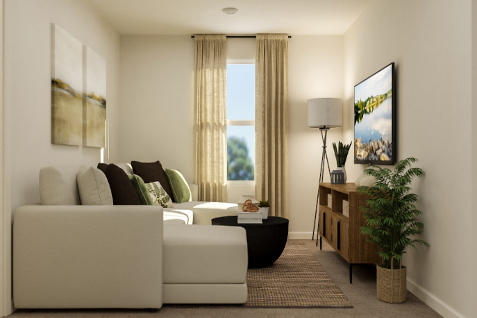 A living room with a white couch and a coffee table.