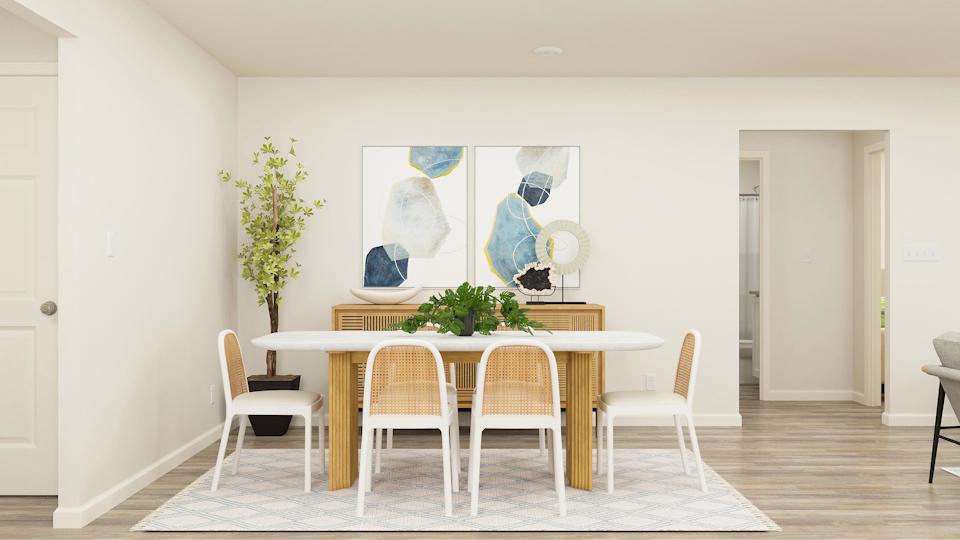 A dining room with a table and chairs.