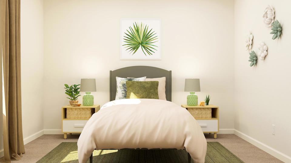 A bedroom with a bed and lamps.