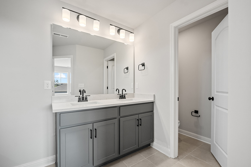 A bathroom with a large mirror.