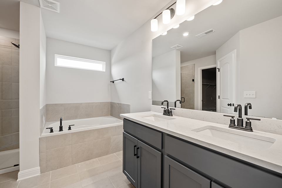 A bathroom with a large mirror.