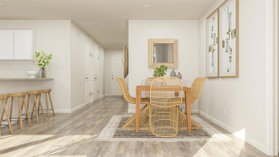 A dining room with a table and chairs.