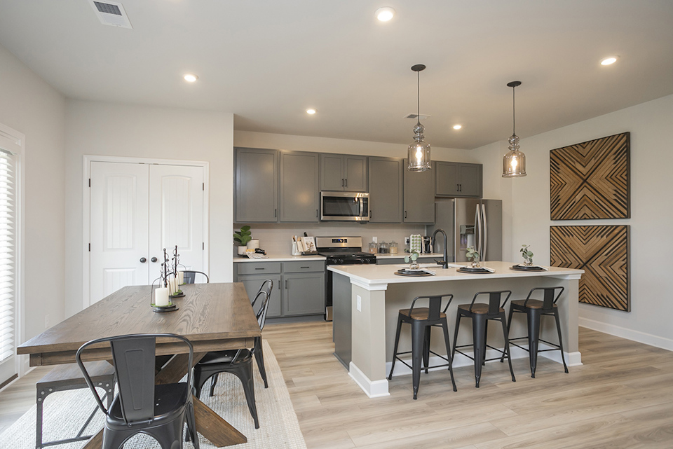 A kitchen with a table and chairs.