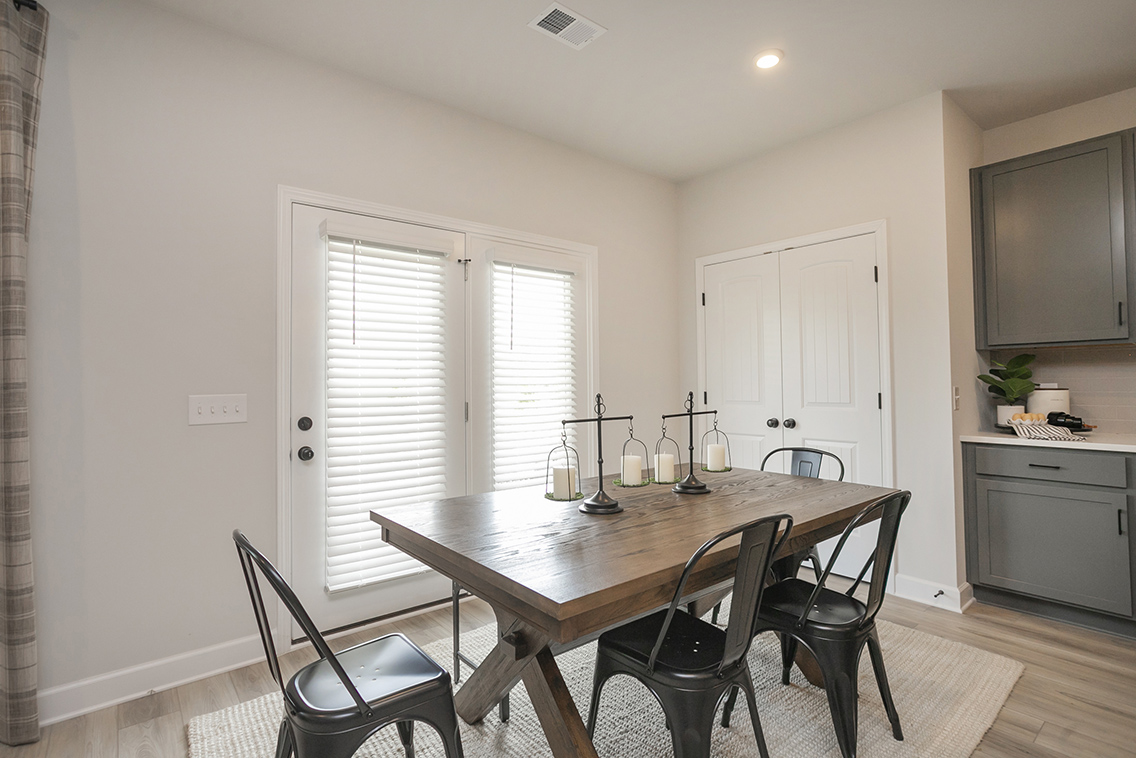 A dining room table with chairs.