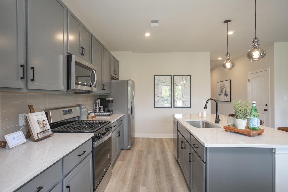 A kitchen with white cabinets.