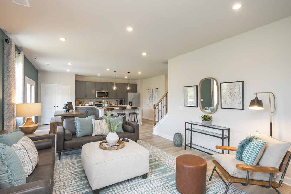 A living room with a large chandelier and a large mirror.