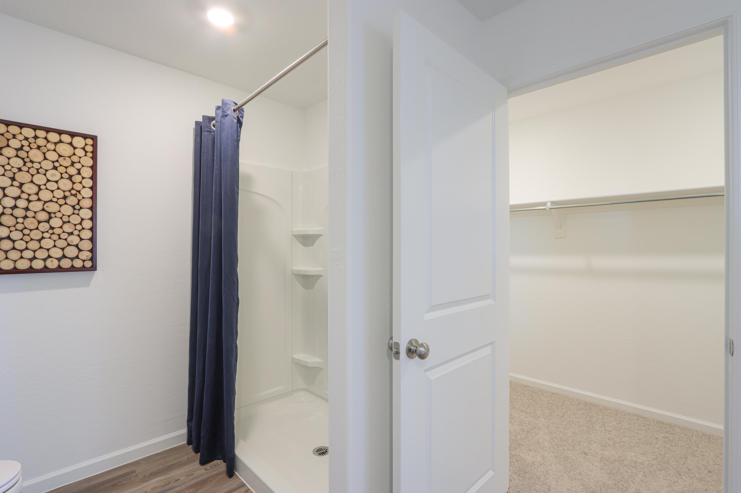 A bathroom with a shower and a bathtub.