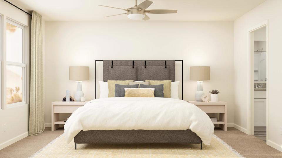 A bedroom with a bed and lamps.