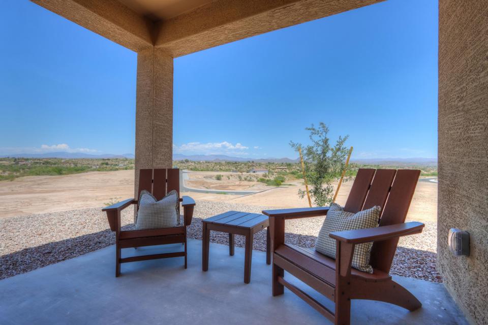 A patio with chairs and a table.