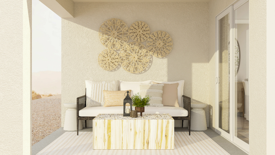 A room with a couch and a table with a bottle of wine.