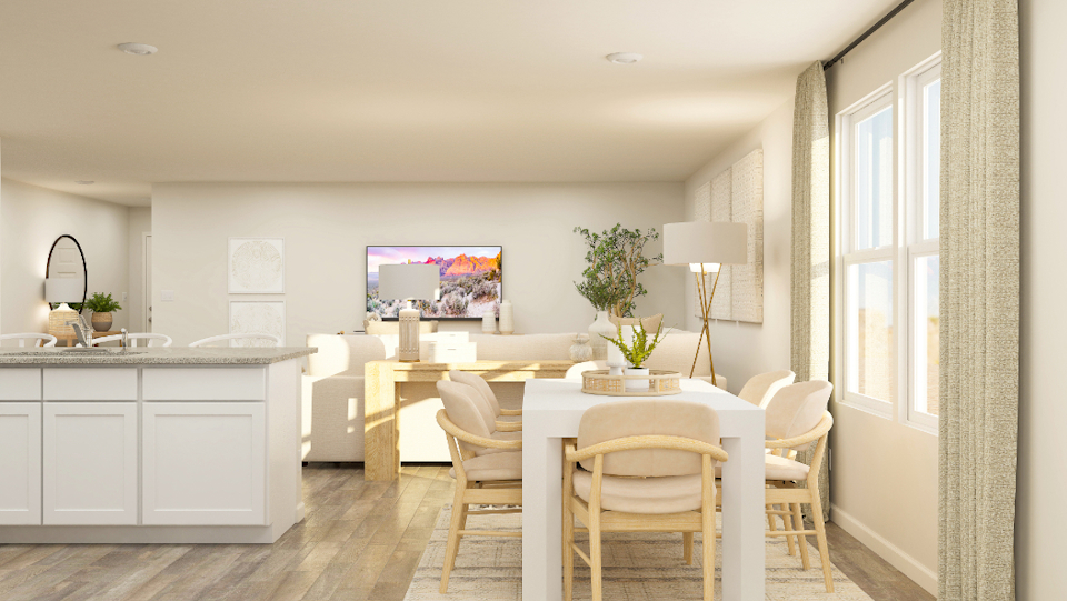 A kitchen with a table and chairs.