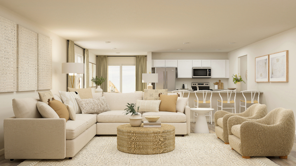 A living room with a large white couch and a table.