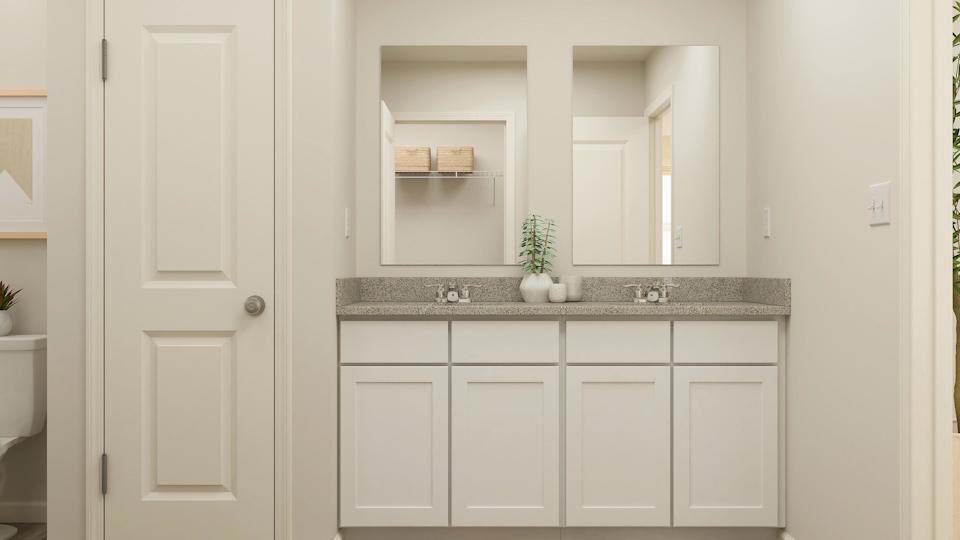 A white kitchen with a marble countertop.