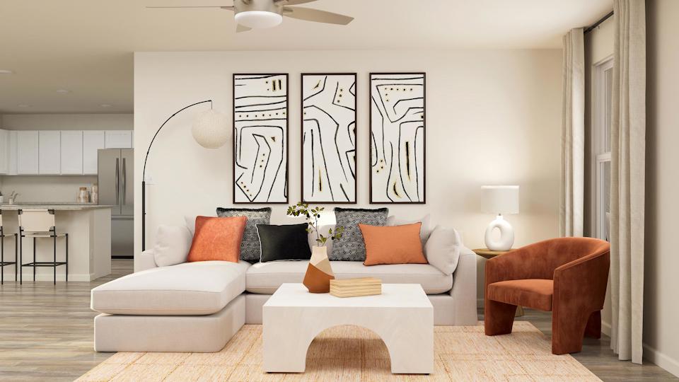 A living room with a white couch and a table.