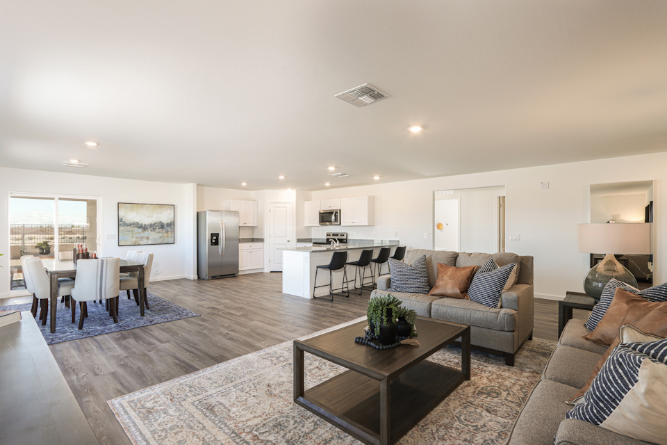 A large living room with a large dining room and a large window.