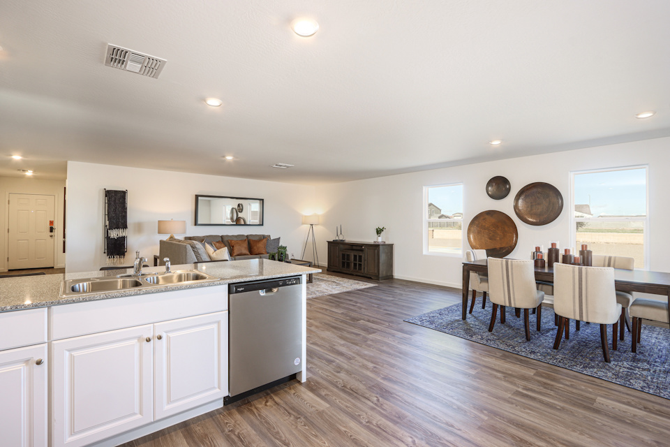 A large kitchen with a wood floor.