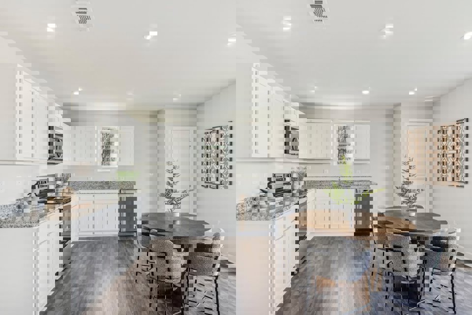 A kitchen with white cabinets.