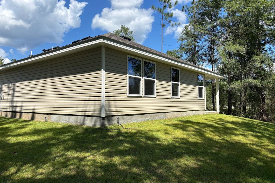 A house with a lawn in front of it.