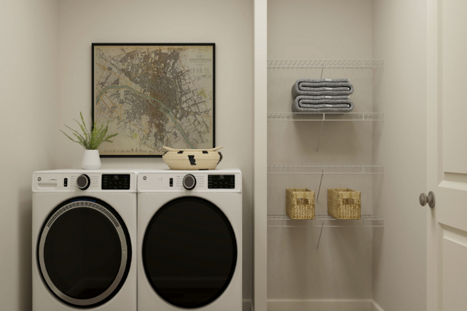 A white laundry room with a washer and dryer.