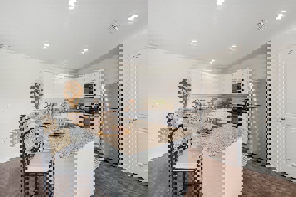 A kitchen with white cabinets.