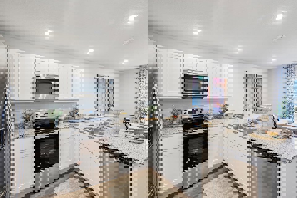 A kitchen with white cabinets.