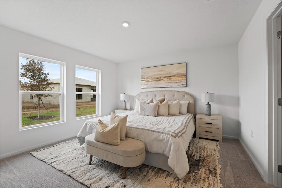 A bedroom with a bed and a couch.