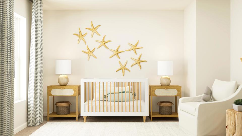 A room with a bed and a table with a lamp on it.