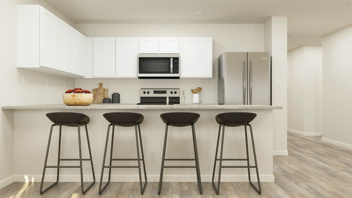 A kitchen with stools and a table.
