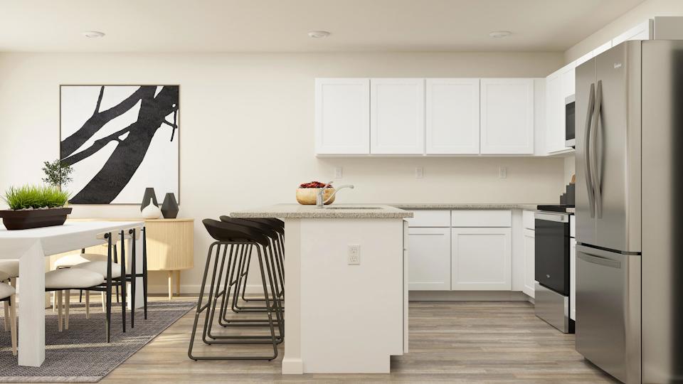 A kitchen with white cabinets.