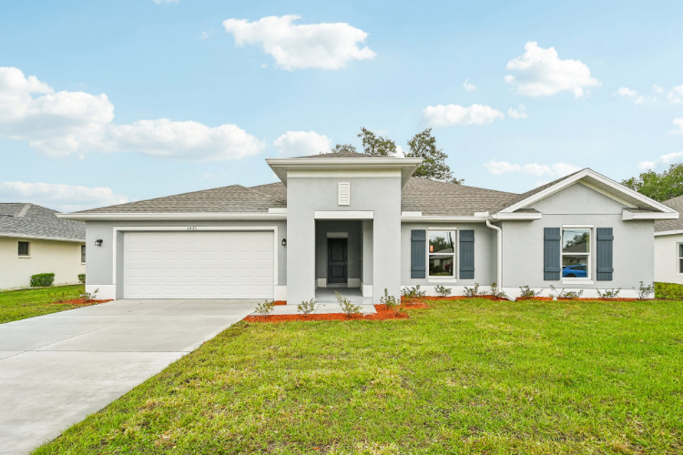 A white house with a garage.
