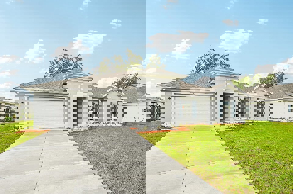 A white house with a driveway.