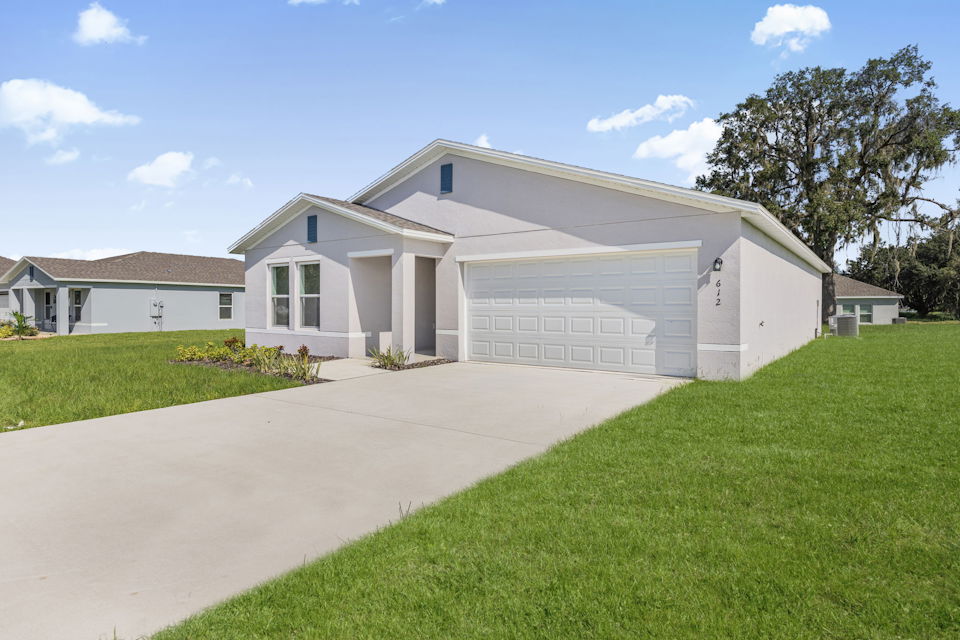 A white house with a driveway.