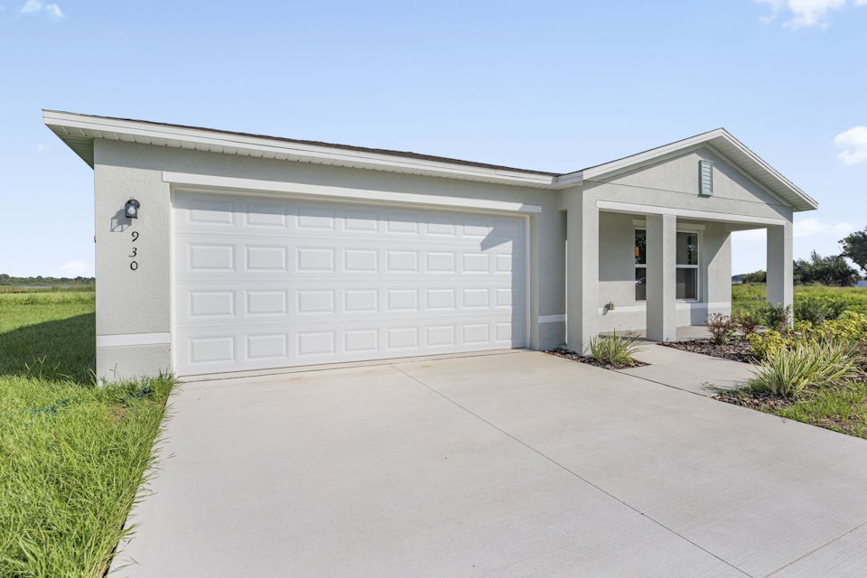 A white garage with a driveway.