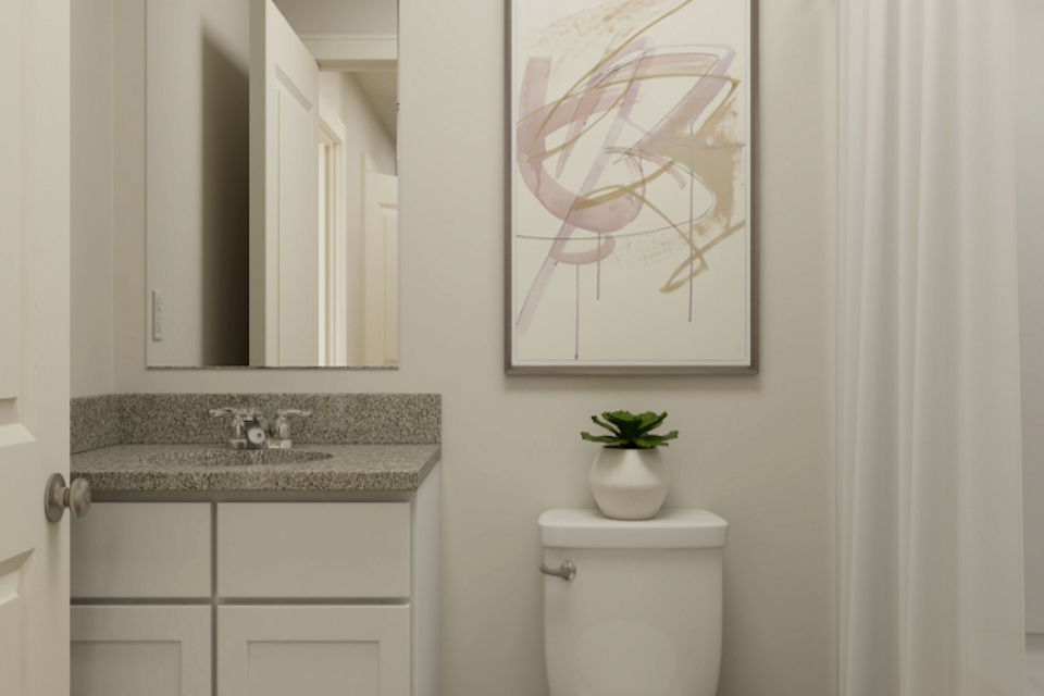 A bathroom with a plant on the wall.