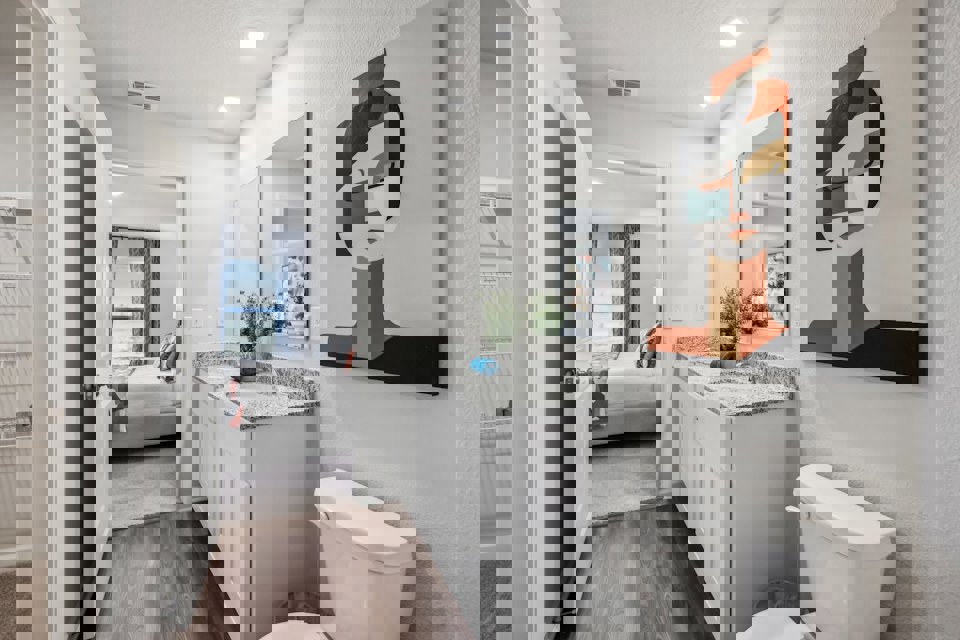 A bathroom with a large mirror.