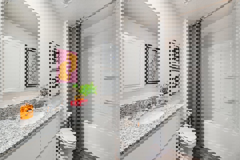 A bathroom with a tub sink and toilet.