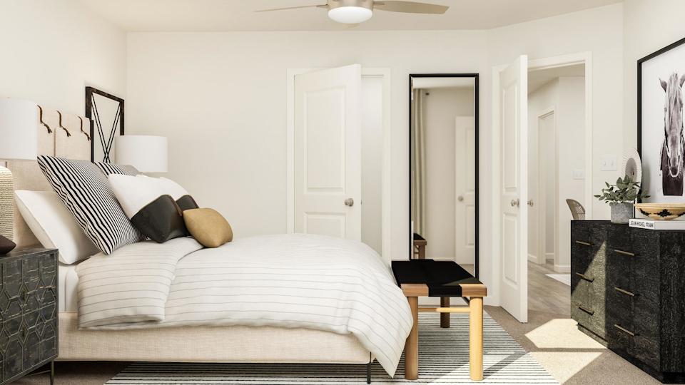 A bedroom with a bed and a piano.