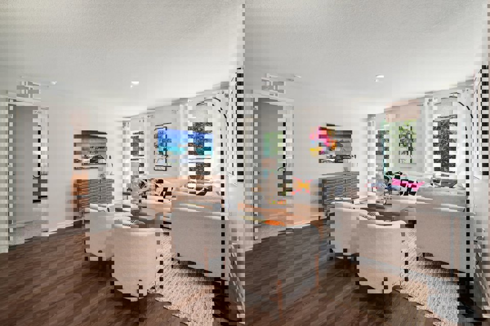 A living room with a couch and chairs.