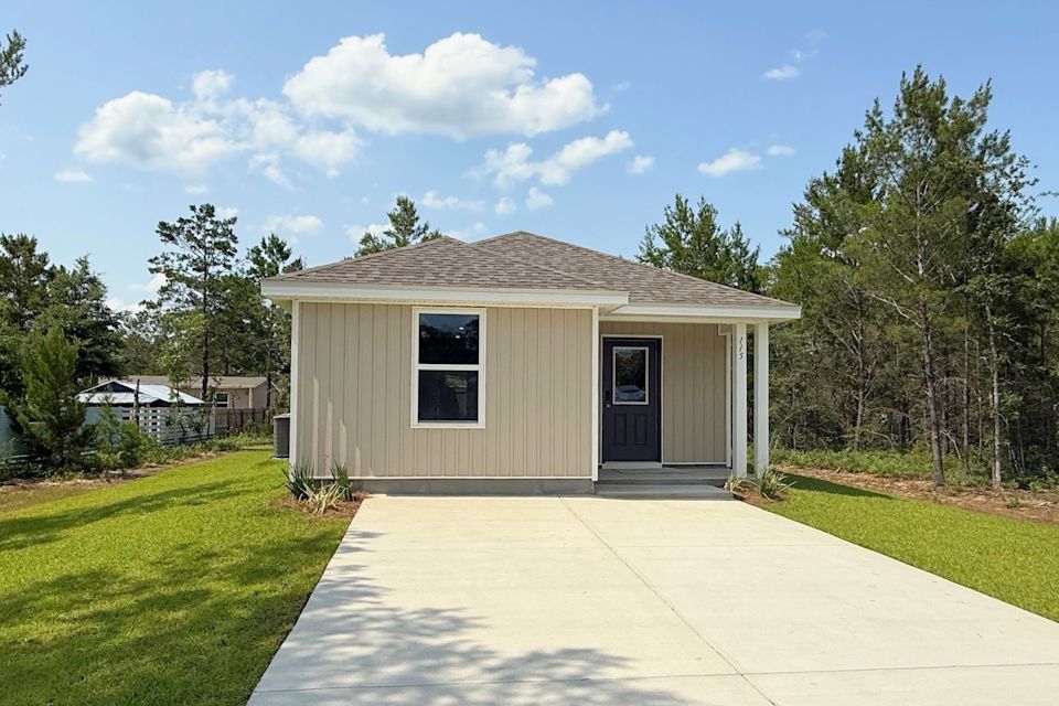 A small building with a driveway.