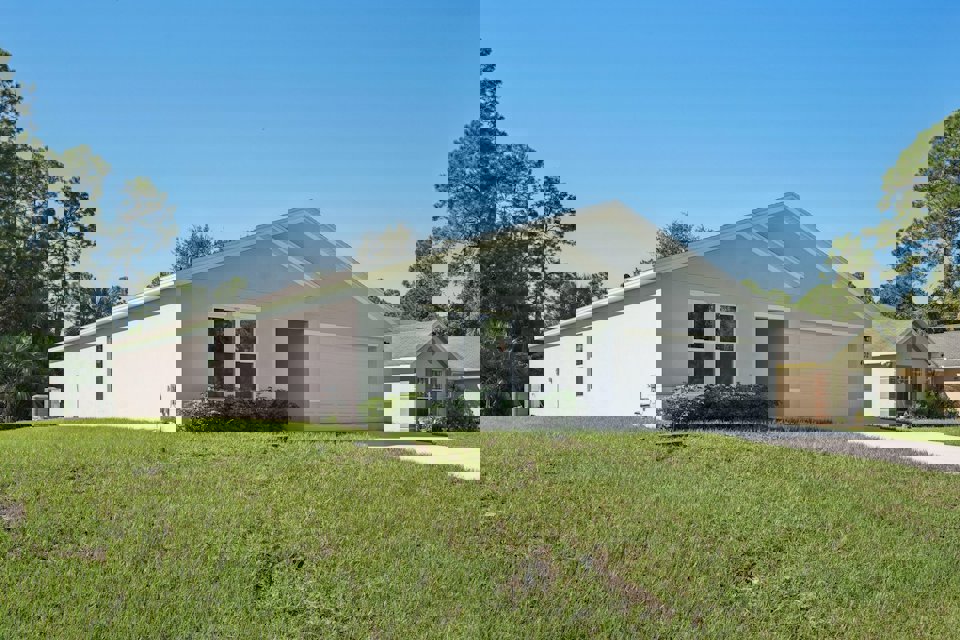 A white house with a garage.