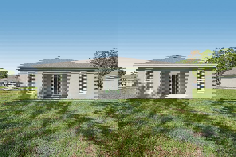 A house with a grass yard.