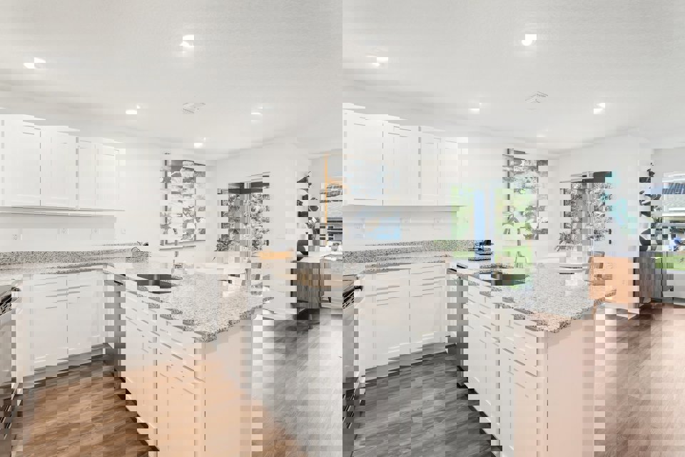 A kitchen with white cabinets.