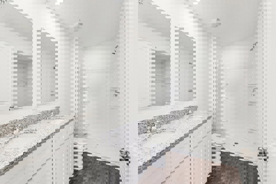 A bathroom with a marble countertop.